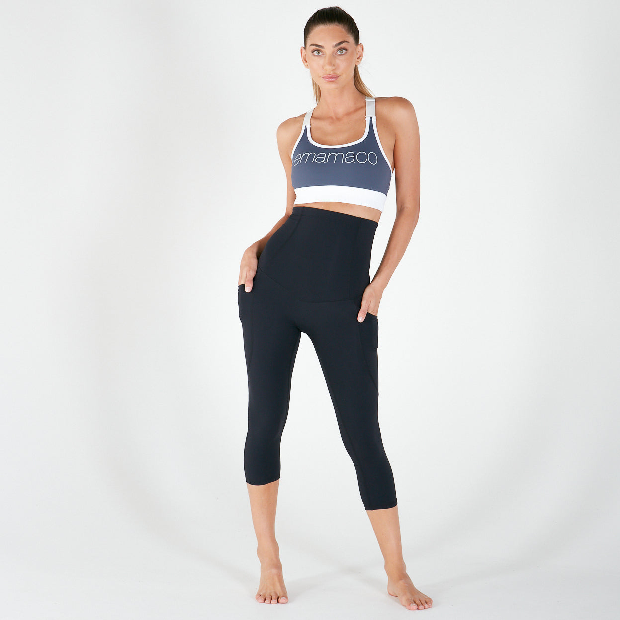 Woman in navy blue activewear showcasing Emamaco shapewear leggings with pockets