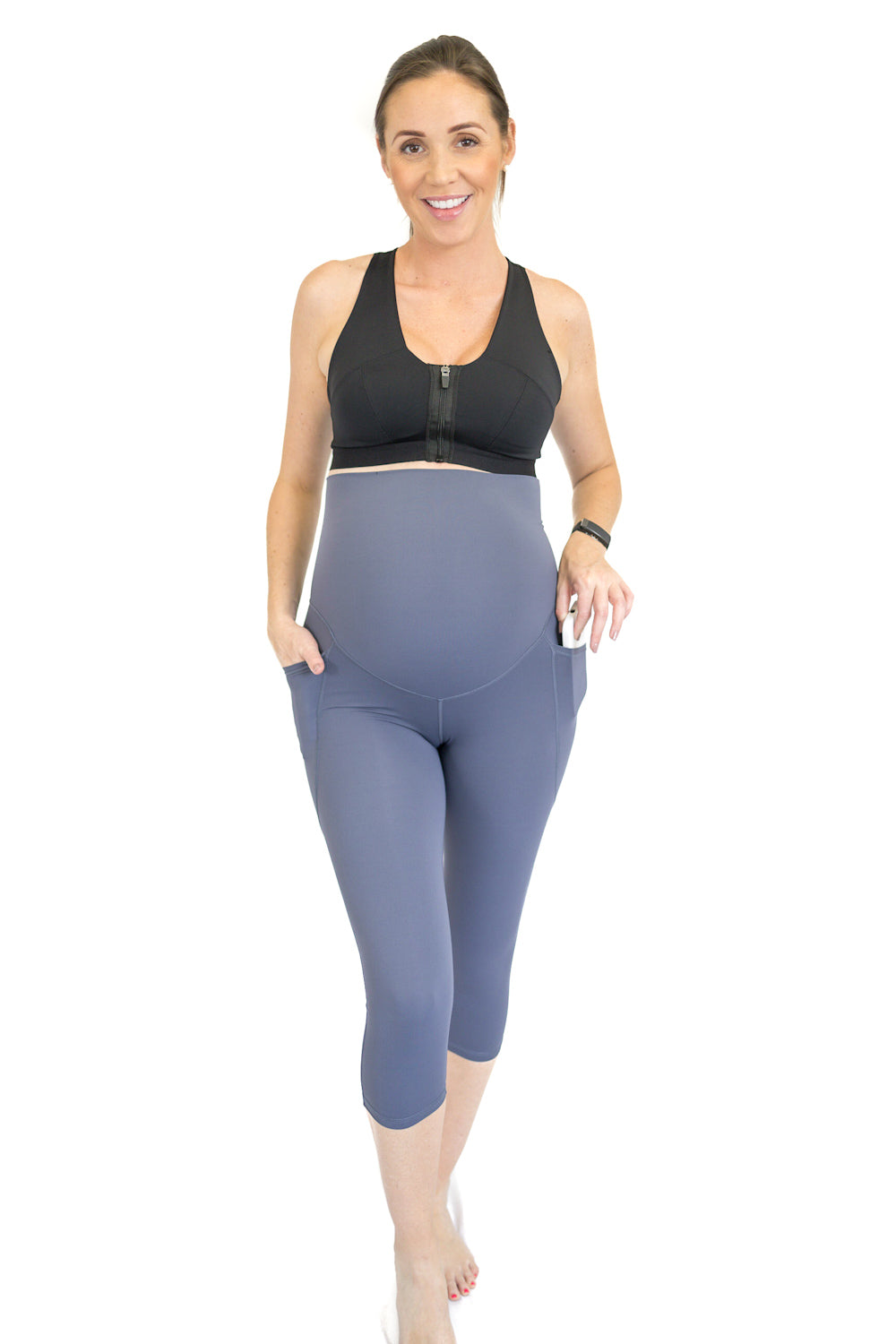 Woman in black tank top and gray capri maternity leggings, showcasing completely specialised design