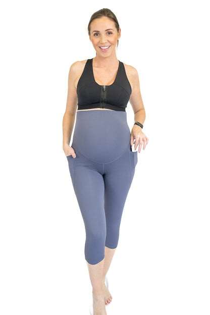 Woman in black tank top and gray capri maternity leggings, showcasing completely specialised design