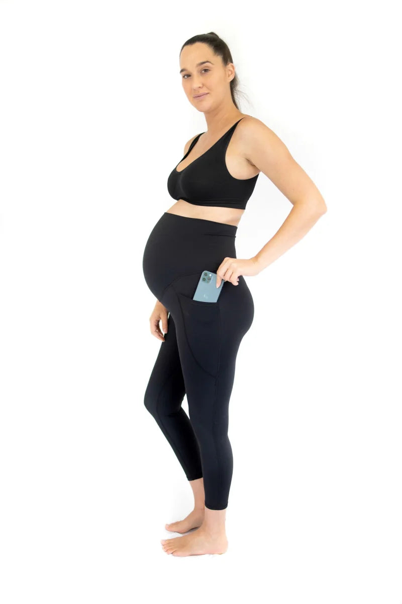 Pregnant woman in black workout attire showcasing Emamaco maternity leggings