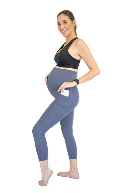 Pregnant woman in side pose wearing Emamaco maternity leggings for active comfort