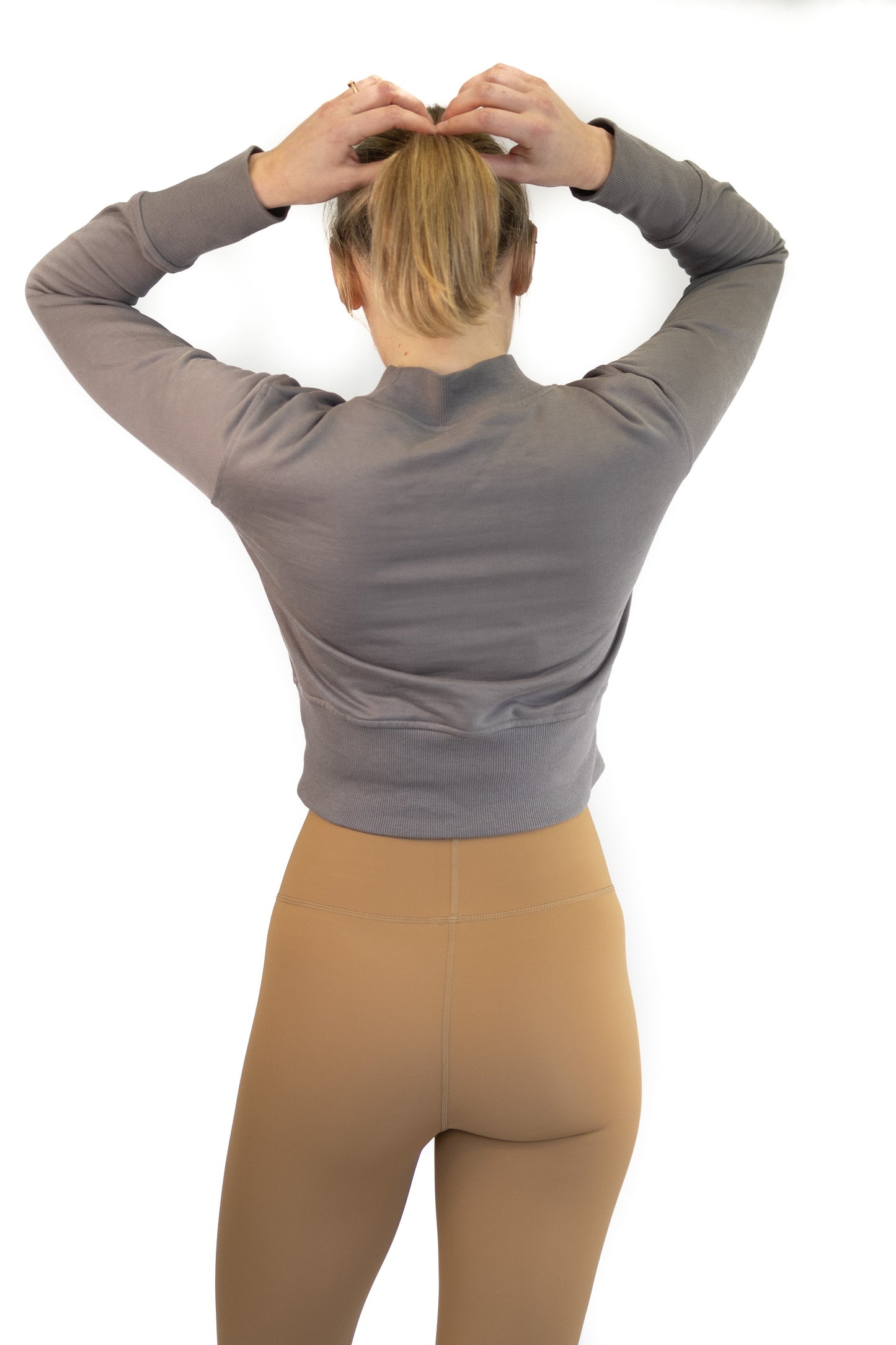 Person with blonde hair in gray top and tan pants, modeling 7/8 Shaper Move Leggings, final sale