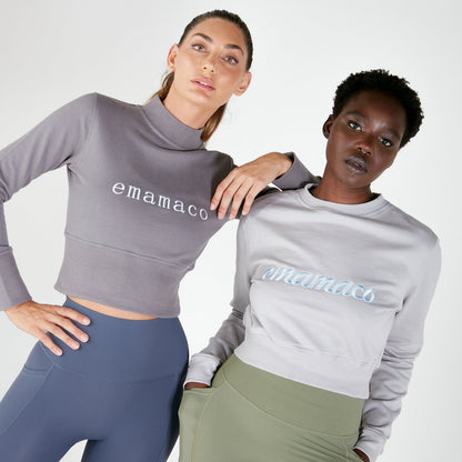 Two women in crisp charcoal grey athletic apparel showcasing the Charcoal High Neck Jumper