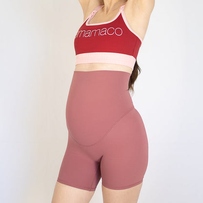 Woman wearing emama Maternity Bike Shorts in the newest colour rose with red sports bra