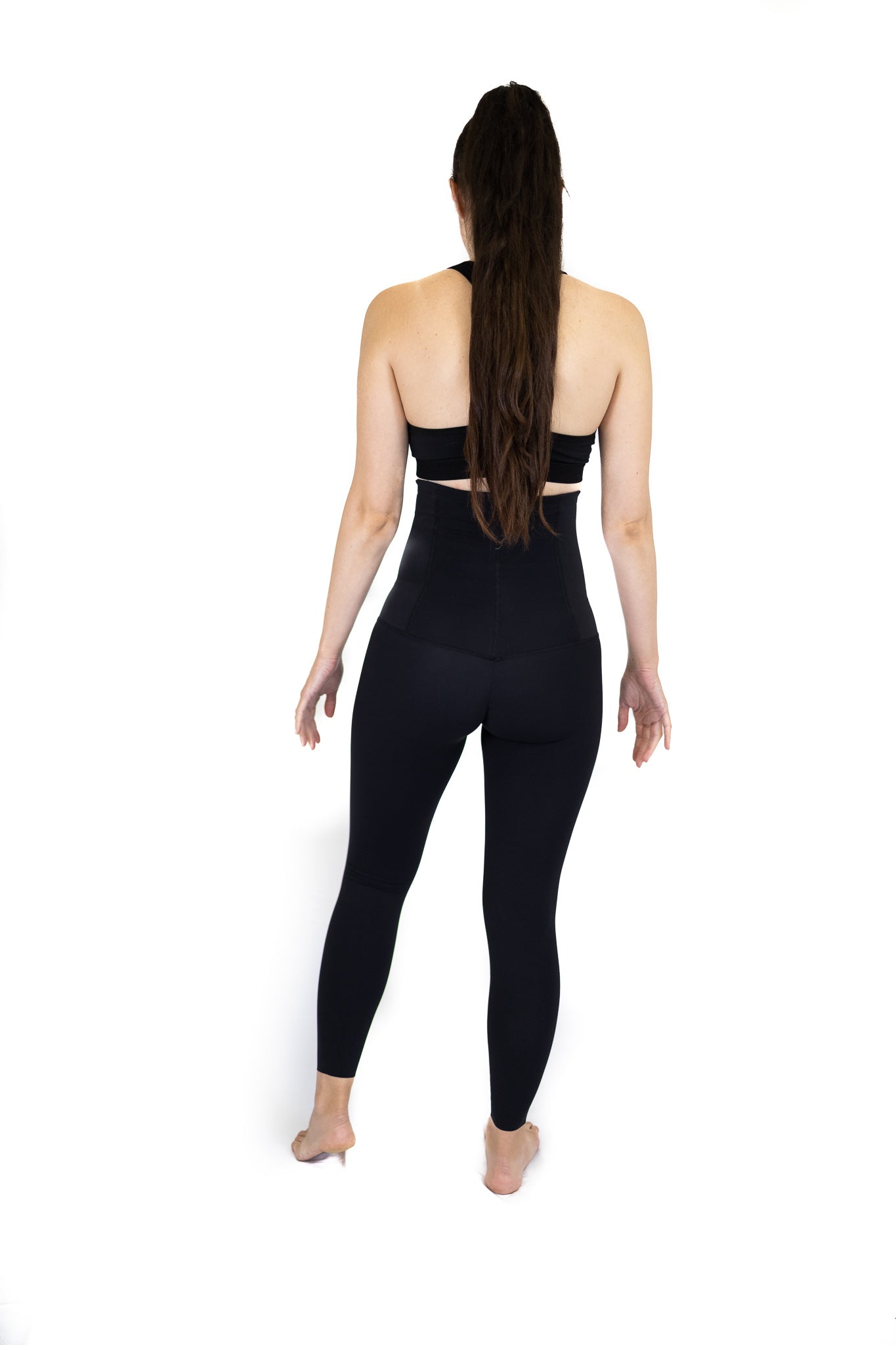 Woman in black top and fitted pants showcasing best post partum Pregnancy Recovery leggings