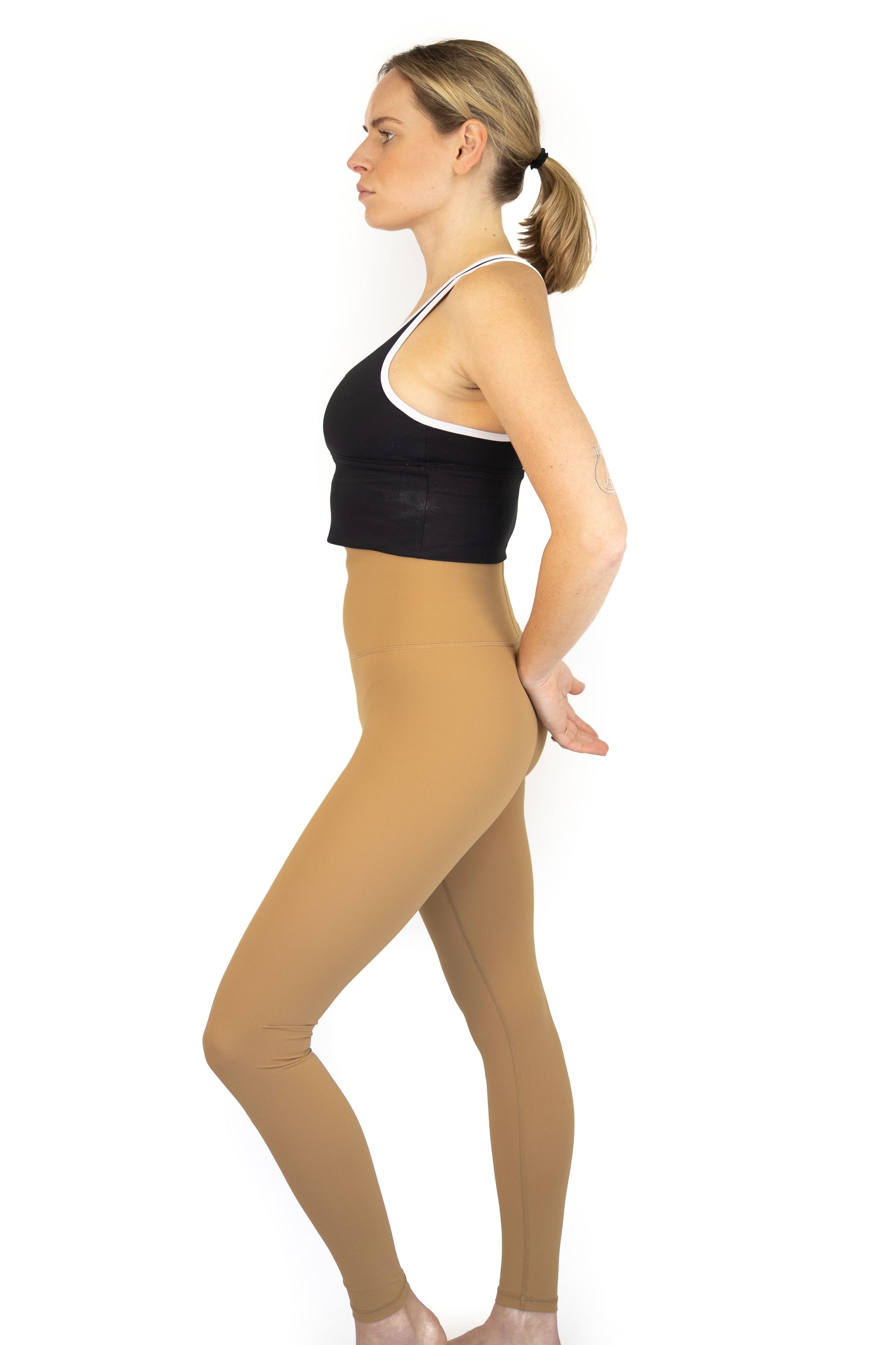 Woman in black sports bra and tan leggings from Shaper Move, final sale, limited sizes