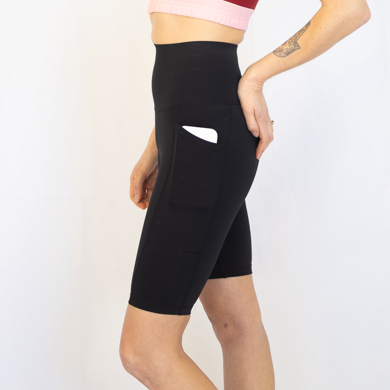 High-waisted black compression long shorts with side pocket, perfect for maternity and pet hair