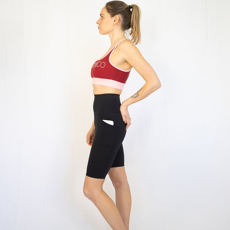 Woman in athletic wear showing profile view of Shaper Move Long Shorts for maternity