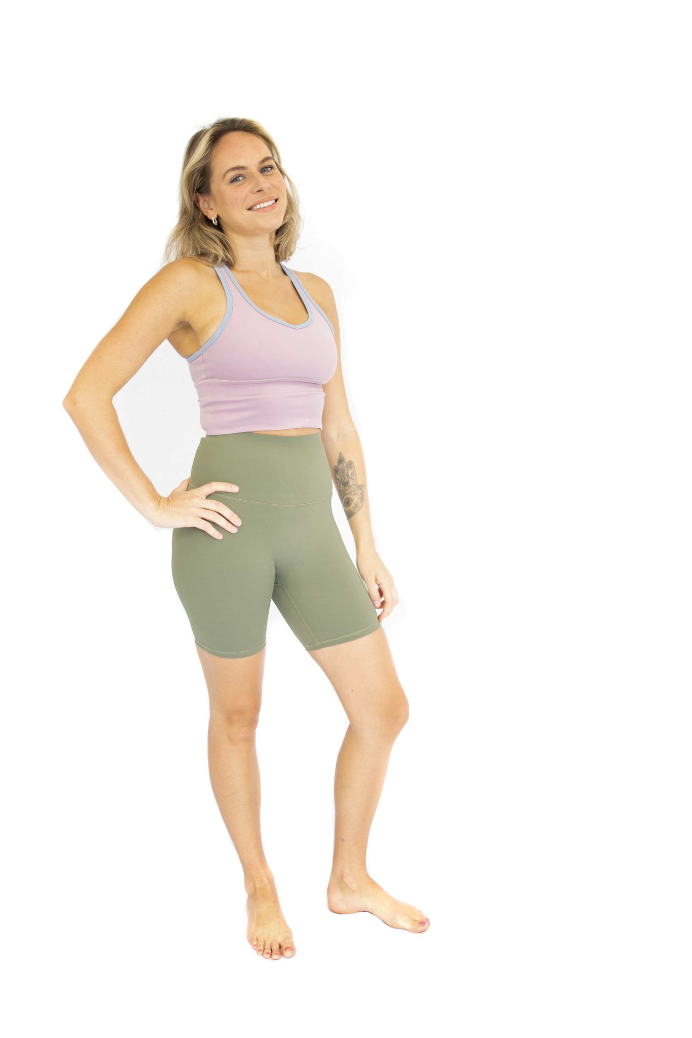 Woman in light purple top and olive green Shaper Move Shorts on final sale