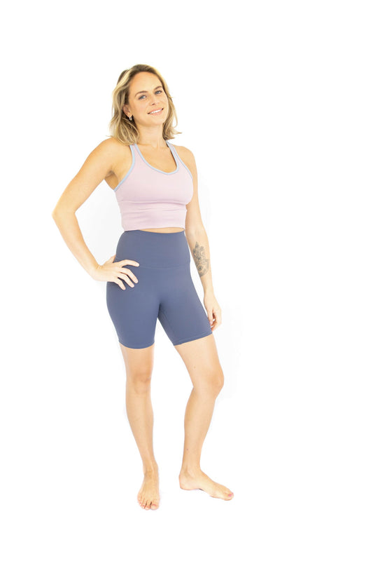 Woman in pink crop top and blue Shaper Move Shorts on final sale with limited sizes remaining