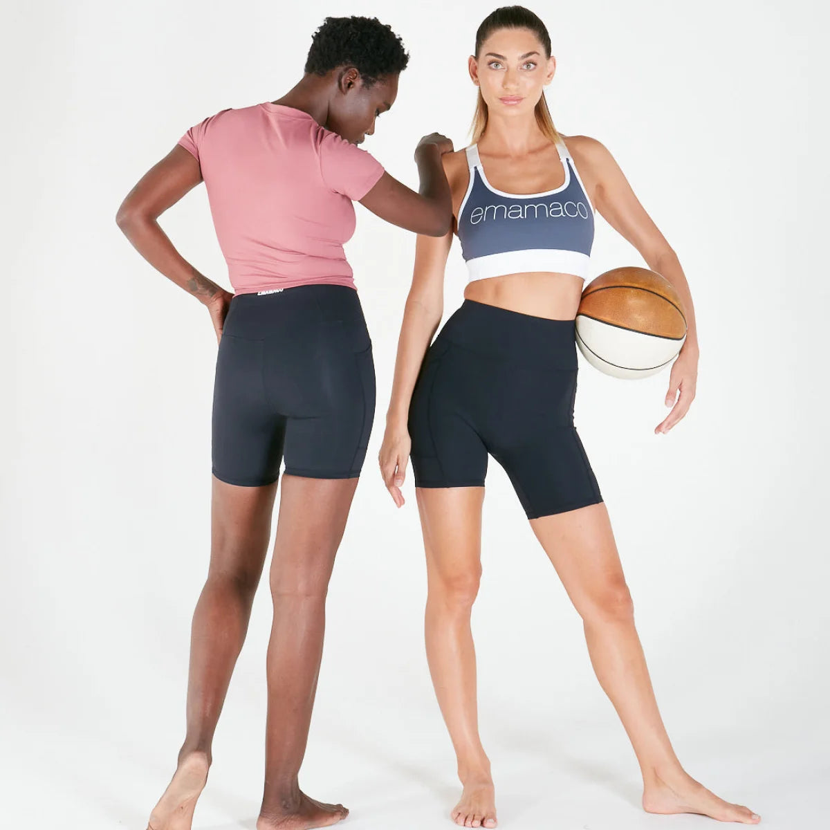 Two women in V-back bike shorts, one holding a basketball, showcasing Vibe V Shorts